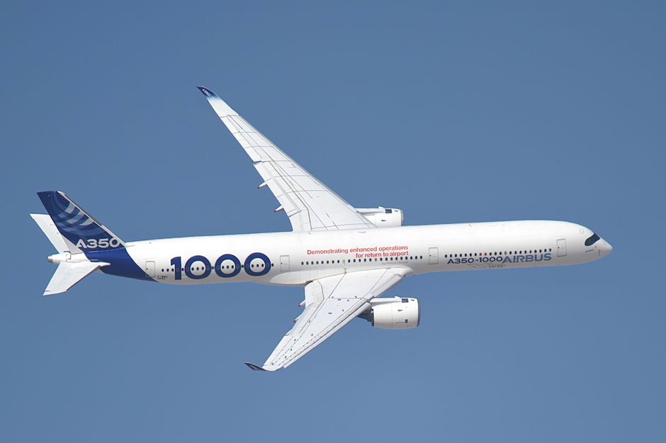 Airbus A350-1000 plane soaring in a clear sky, showcasing modern aerospace technology.