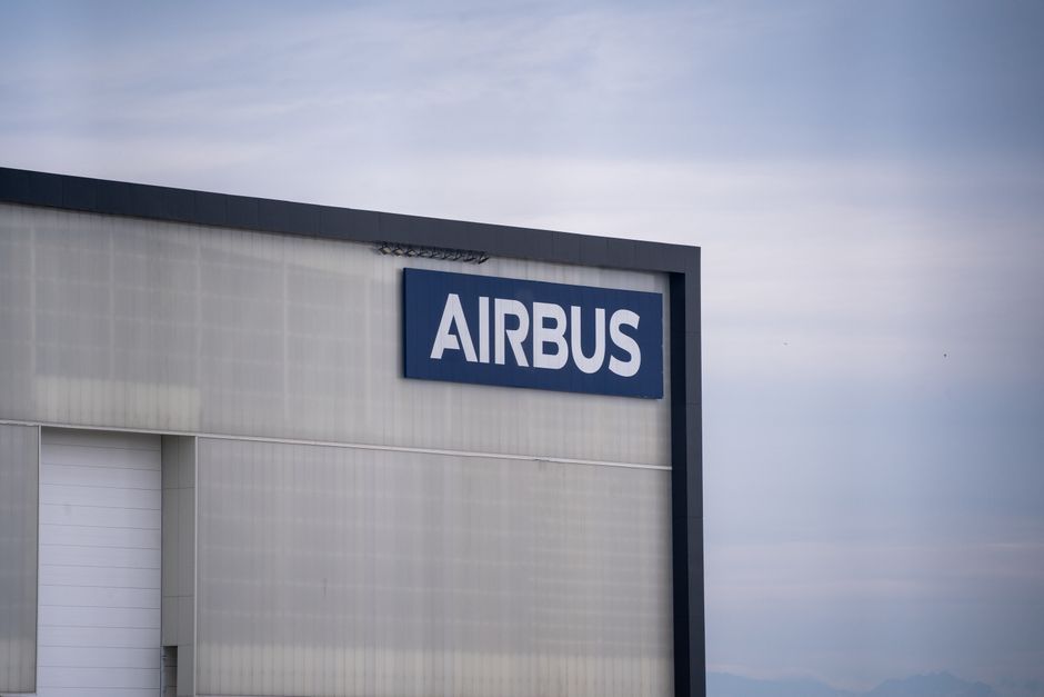 Exterior view of an Airbus factory building with the company logo prominently displayed.