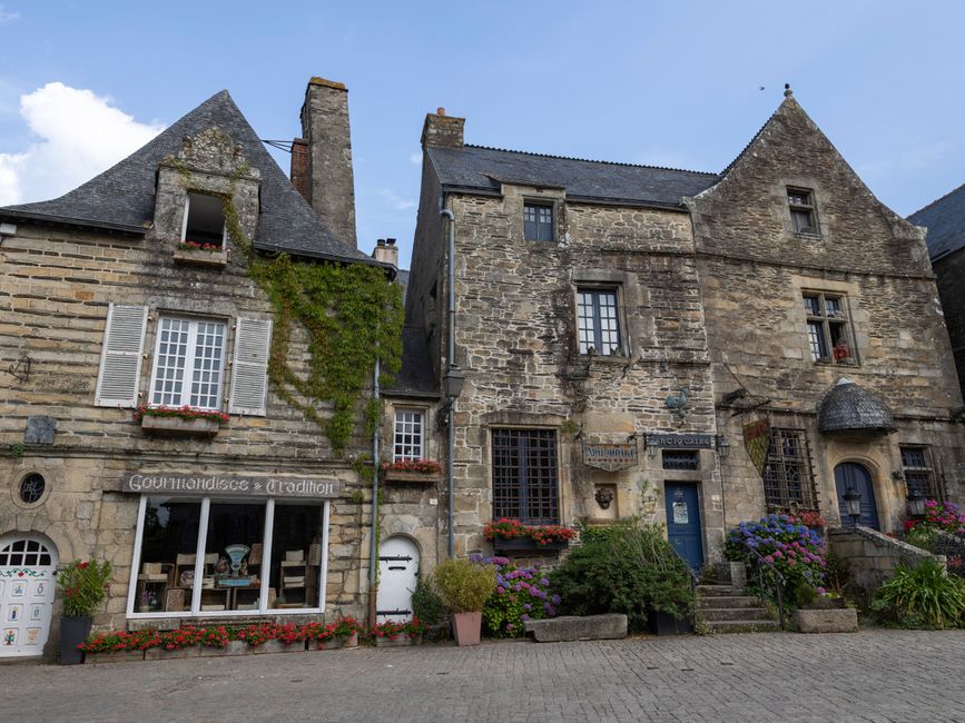 Quaint stone structures in Rochefort-en-Terre, showcasing Breton architecture.