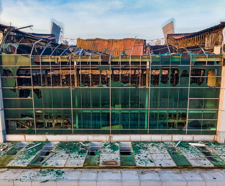 Aerial shot of a damaged building facade with broken glass windows in Banten, Indonesia.