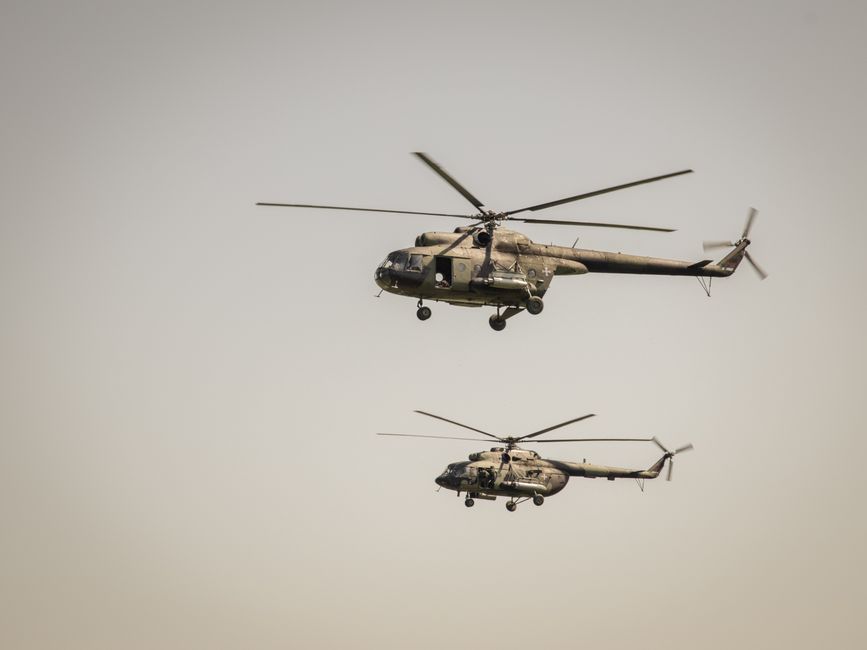 Two military helicopters flying in formation in the clear sky over Belgrade, showcasing aerial power.