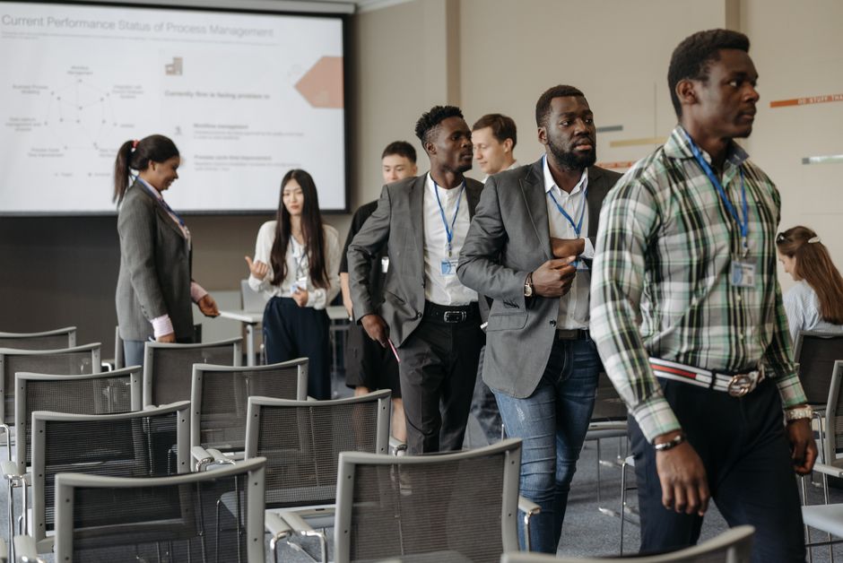Diverse group of professionals attending a business conference in a modern conference room.