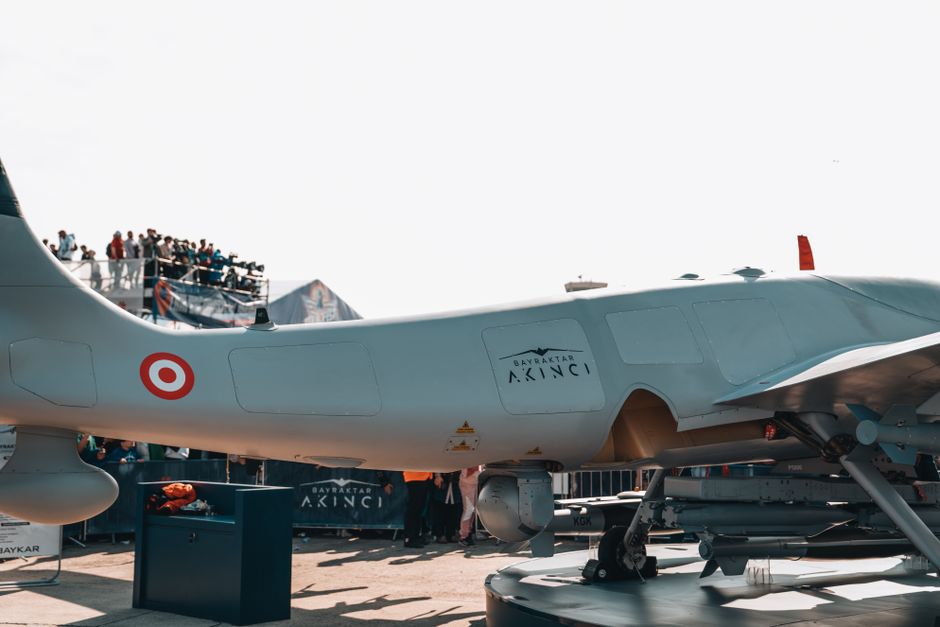 Bayraktar Akinci drone displayed at a busy airshow with spectators.