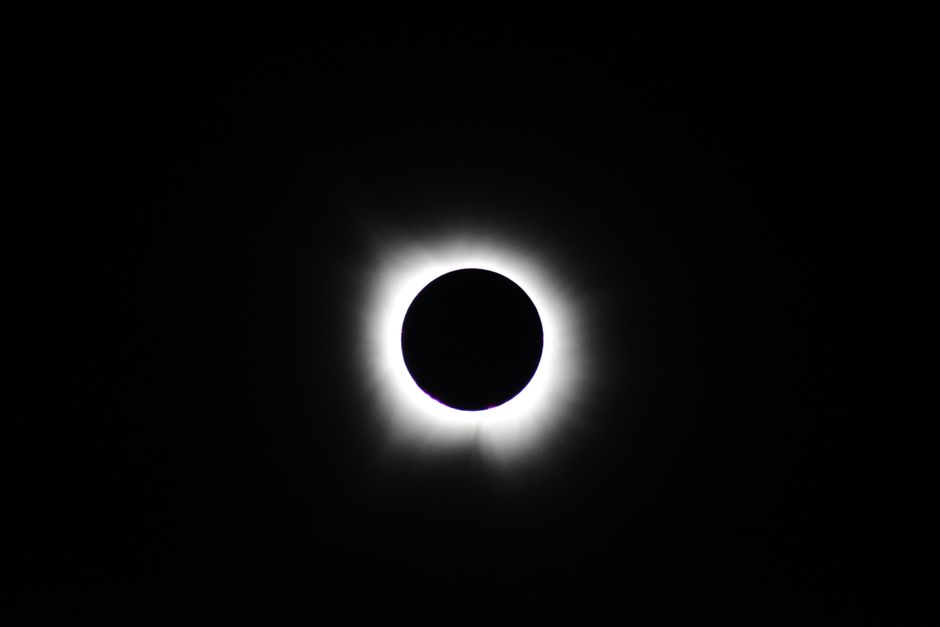 Stunning image of total solar eclipse showing the sun's corona against a dark sky.