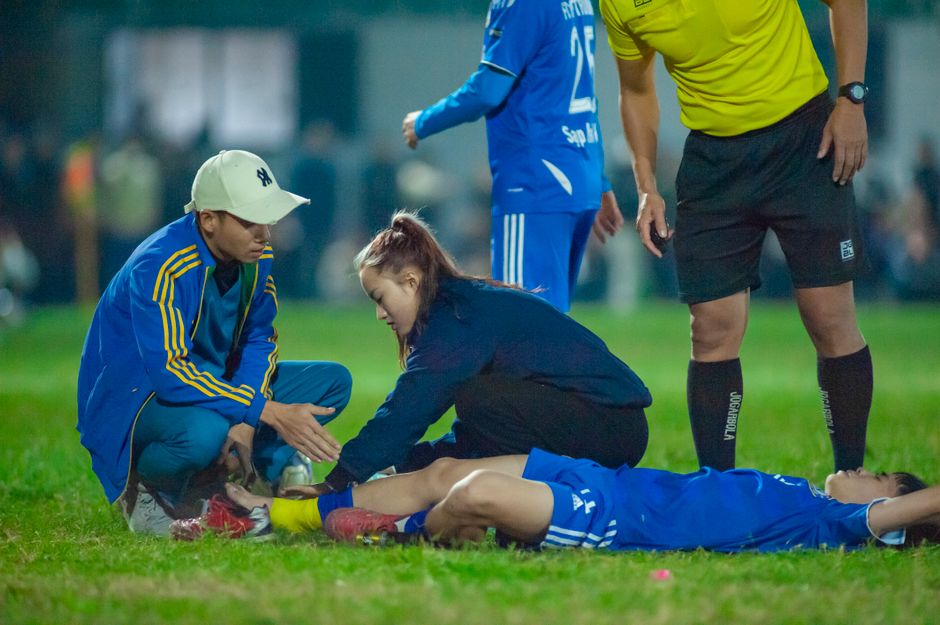 Medical team attends to an injured soccer player in HÃ Ná»™i, Vietnam.