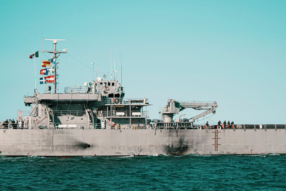 A navy warship sailing in the ocean near Veracruz, Mexico, with flags flown high.