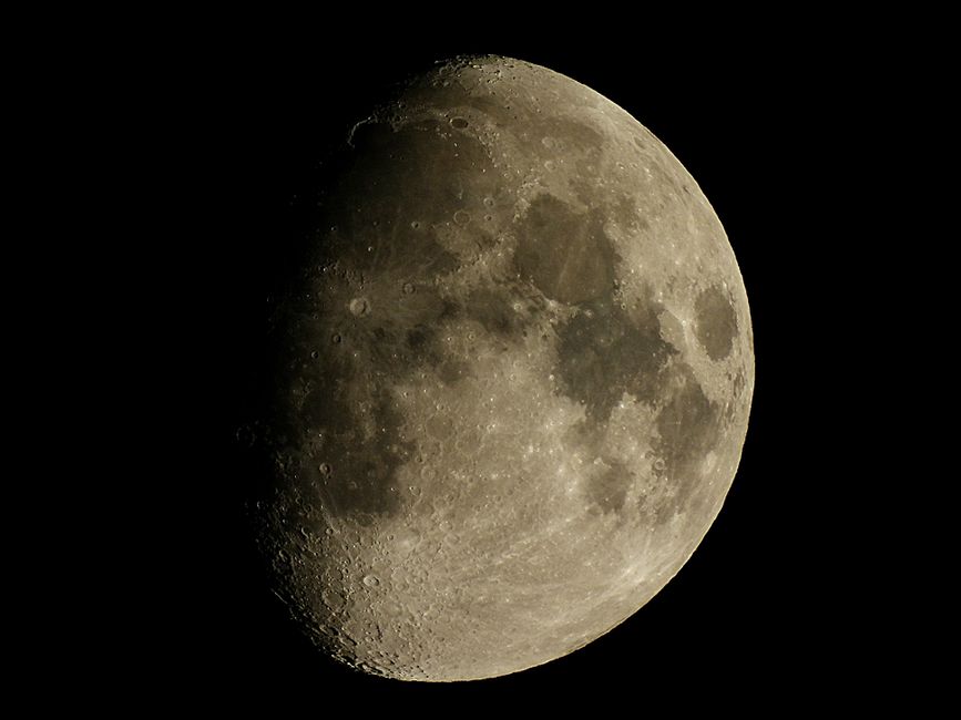 Captivating detailed photograph of the waxing gibbous moon against a dark sky.