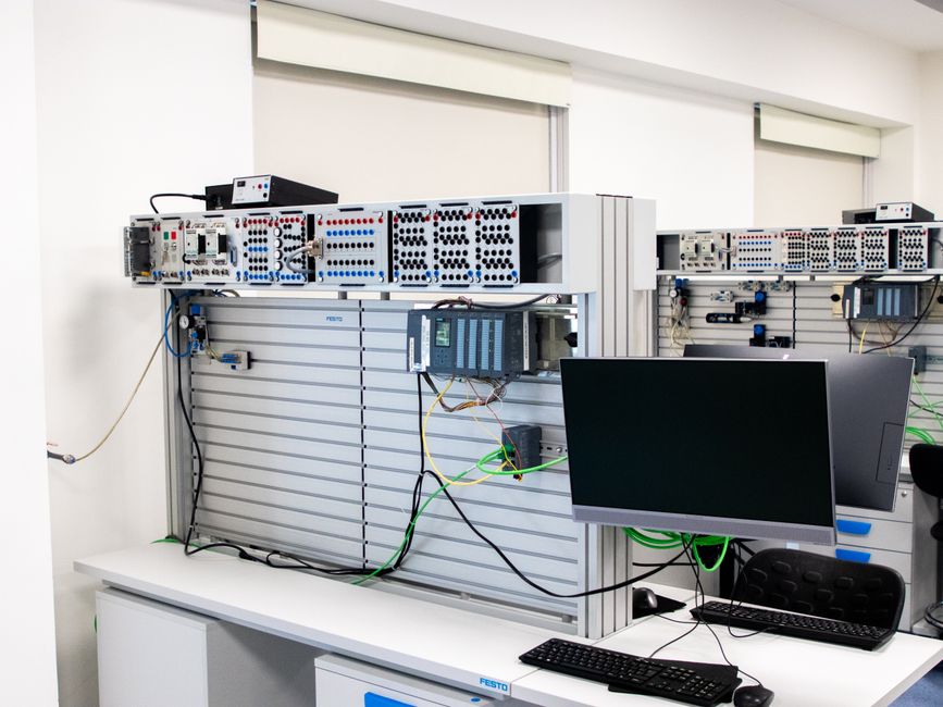 Un espace de travail technologique avec serveurs informatiques et ordinateurs.