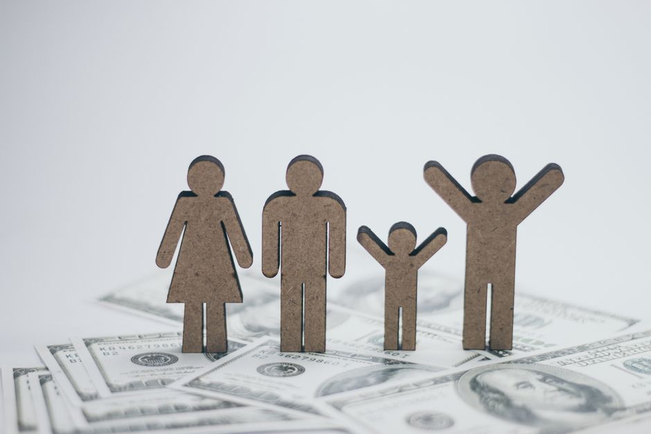 Figurines en bois représentant une famille sur des billets