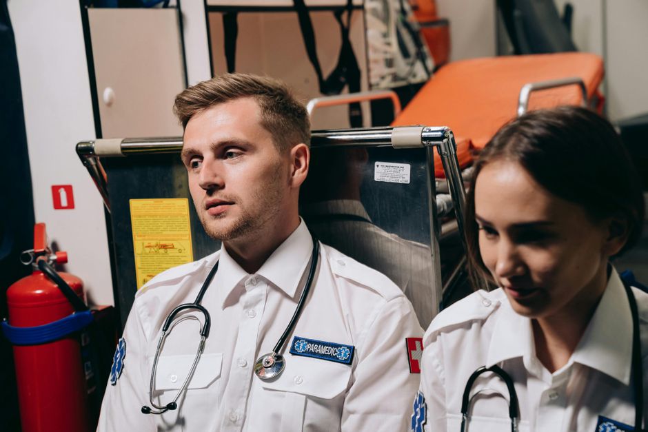 Deux ambulanciers dans une ambulance avec leur équipement médical.