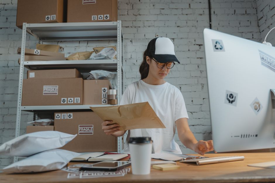 Une femme trie des colis dans un bureau de logistique