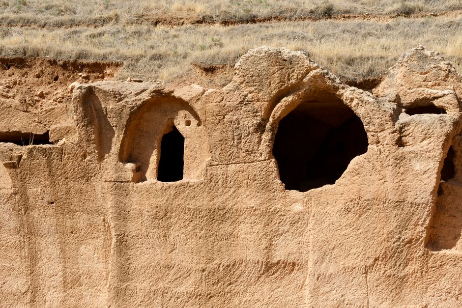Entrée d'une grotte préhistorique avec ouvertures arquées dans la roche